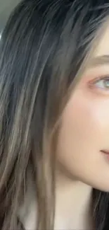 Close-up profile of a woman with long hair in soft light.
