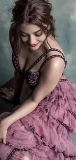 Woman in a pink dress sitting gracefully.