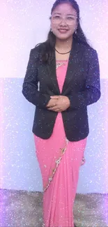 Woman in pink saree and black blazer posing gracefully.