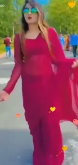 Woman in a stylish red dress walking outdoors.