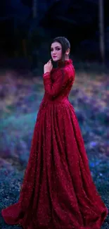 Elegant woman in red gown against a forest background.