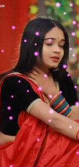 Woman in red saree with glowing pink lights.