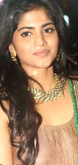 Elegant woman in traditional attire with gold jewelry.