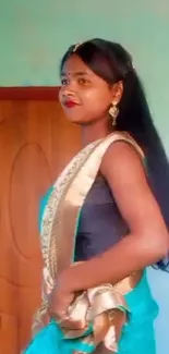 Woman posing elegantly in a traditional saree.