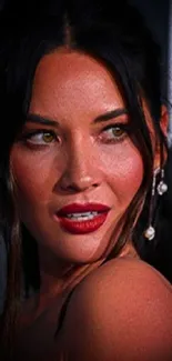 Elegant woman with dark hair and red lipstick in close-up.