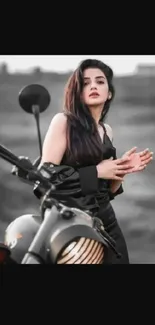 Woman in black with motorcycle on gray background.