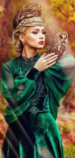 Elegant woman in green dress holding owl in a scenic autumn setting.