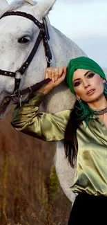 Woman with green turban and white horse in nature.