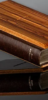 Elegant wooden Bible on reflective surface, dark background.