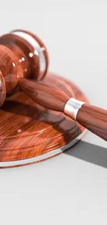 Elegant wooden gavel on a smooth surface.