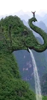 Elephant-shaped mountain with waterfall in lush green scenery.