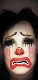 A vibrant and emotional clown face with bold makeup on a dark background.