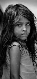 Black and white portrait of a young girl with expressive eyes.