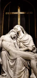 Marble sculpture of two figures with cross in background.