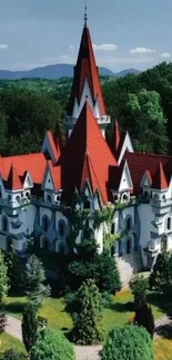 Enchanted castle with red roofs amidst lush greenery.