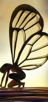 Silhouette of fairy with luminous wings on a mystical background.