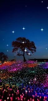 A tree stands under a starry sky amidst colorful glowing fields at night.