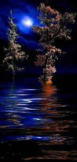 Moonlit trees reflected in water under a dark blue night sky.