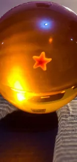 Golden sphere with star glowing on rough surface.