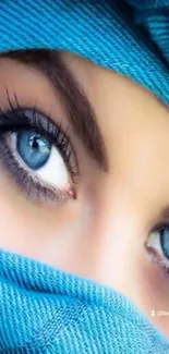 Close-up shot of captivating blue eyes wrapped in a blue fabric.