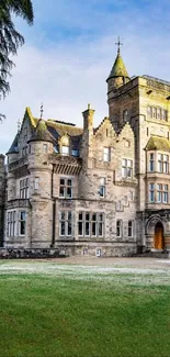 Enchanting stone castle amidst lush greenery and clear sky.