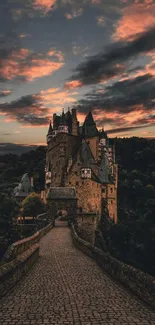 Castle under vibrant sunset sky with stone pathway.