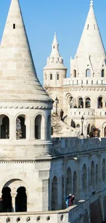 Majestic castle towers under a clear blue sky.