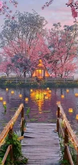 Cherry blossom island with sunset and lanterns reflecting on water.