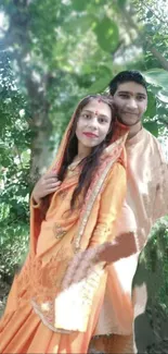 Couple in traditional attire amidst lush forest backdrop.