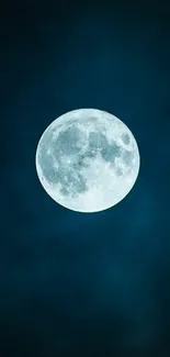 Full moon glowing against a deep blue night sky.