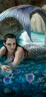 Mermaid resting in turquoise water with shimmering tail.