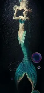 Enchanting mermaid in teal underwater scene for mobile wallpaper.