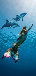 Mermaid swimming with dolphins in deep blue ocean.