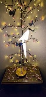 Elegant origami lamp with lights and floral accents on a wooden table.