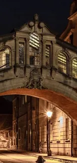 Night view of Oxford's historic bridge and alleyway.