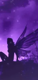 A silhouette of a fairy with wings against a purple backdrop.