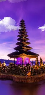 Purple sky over Indonesian temple reflecting on serene waters.