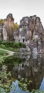 Rock formations reflecting in a calm lake, creating a serene and picturesque scene.