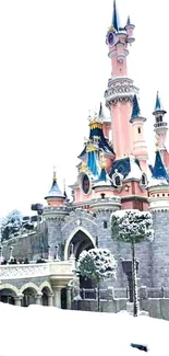 Snow-covered enchanting castle with spires and a fairytale look.