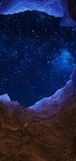 Starry night sky through a rocky cave opening with dark blue hues.