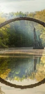 Stone bridge reflecting in calm river surrounded by greenery, tranquil scene.