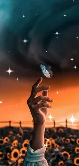 Hand holding butterfly with a sunset backdrop.