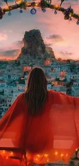 Woman in red overlooking a sunset-lit village.