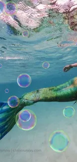 Underwater view of a mermaid swimming gracefully in the ocean.