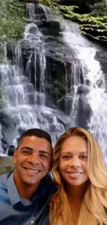 A serene waterfall with smiling couple.