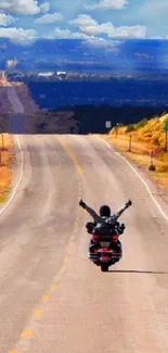 Motorcycle on an endless, scenic highway surrounded by stunning blue sky.