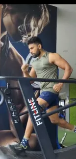 Man running on treadmill in gym setting.