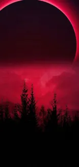 Eclipse nightscape with red glow over forest silhouette.