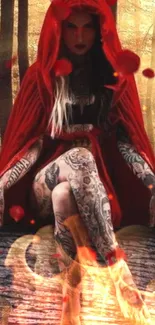 Tattooed woman in red cloak sitting in forest.