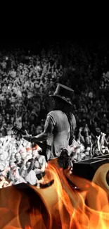 A guitarist performs on stage in front of a lively crowd in black and white.